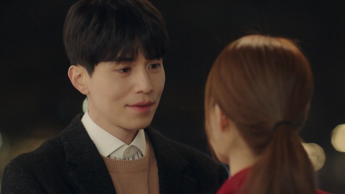 夜景を背景に優しく微笑みあうカップル